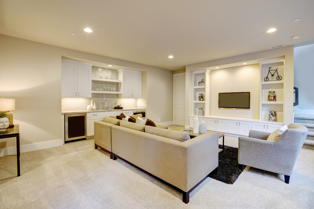 A view of a brightly lit finished basement.