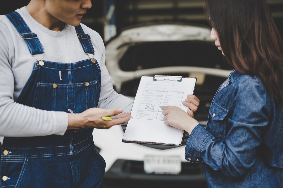 hidden costs of owning an electric car - mechanic showing bill