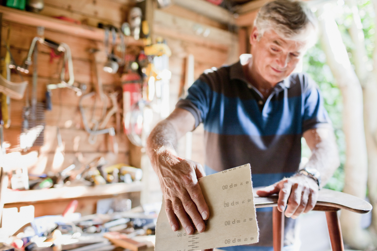 iStock-104821752 productivity hacks man sanding in work shed